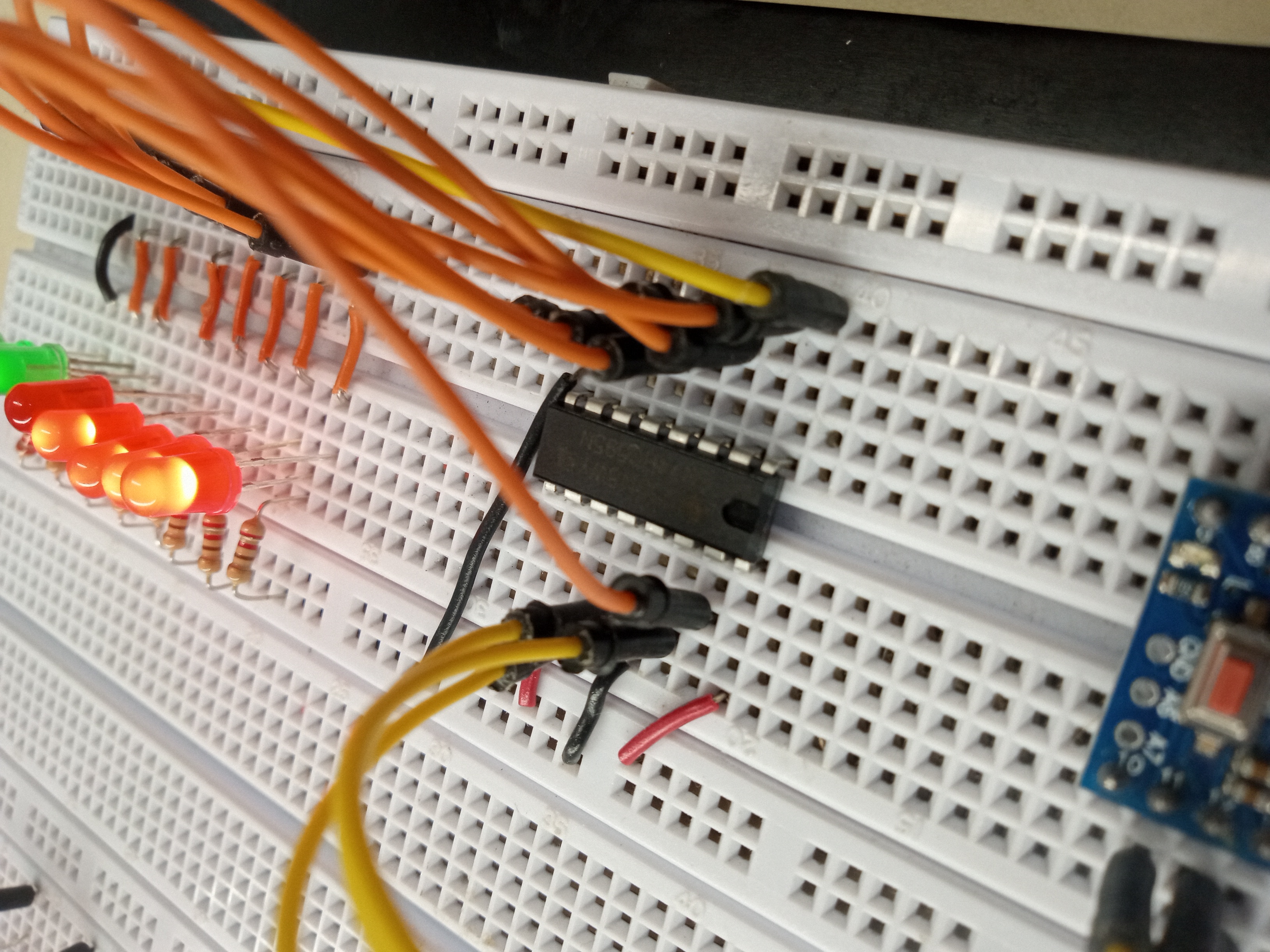 Breadboard shift register project with LEDs lit up.