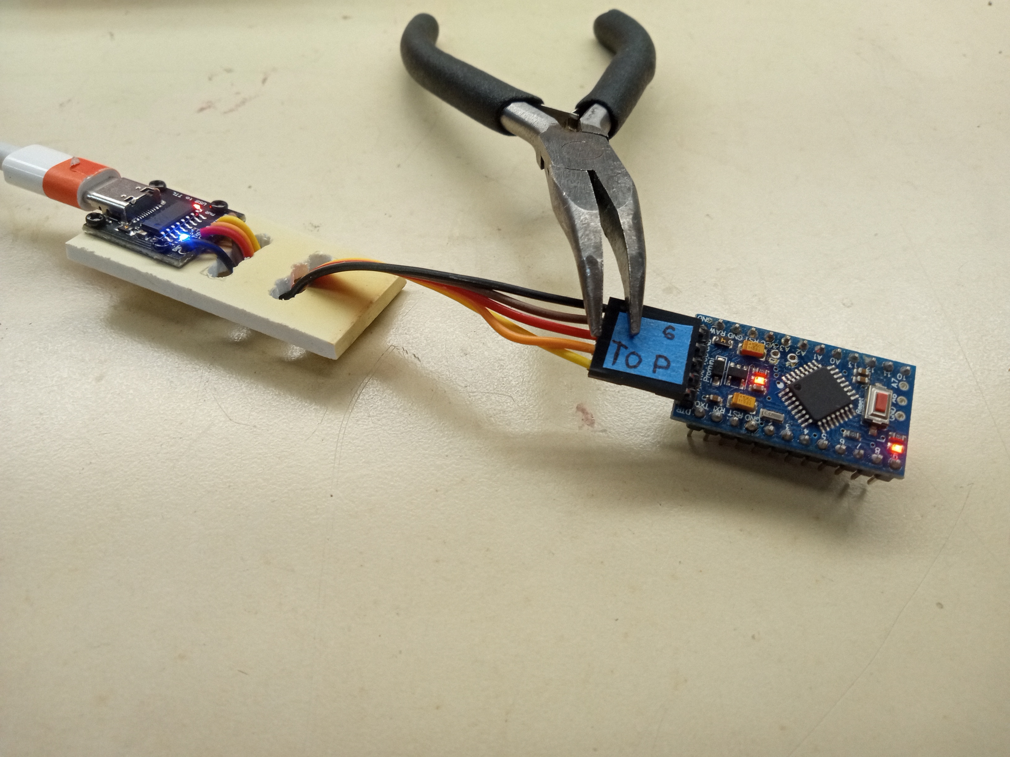 Turned-on USB-C to TTL cable converter with the top label visible