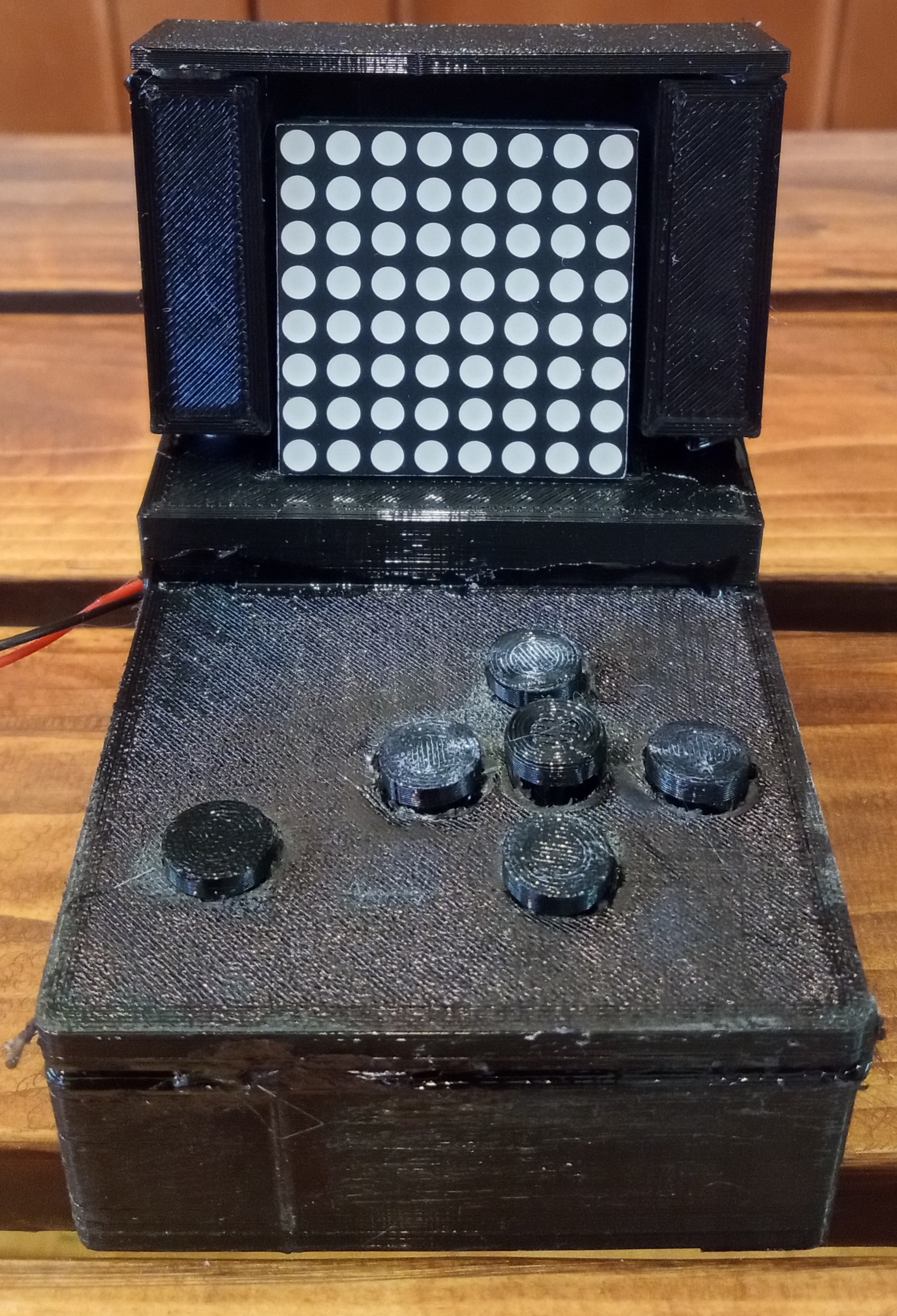 A black LED matrix controller with buttons and a display.