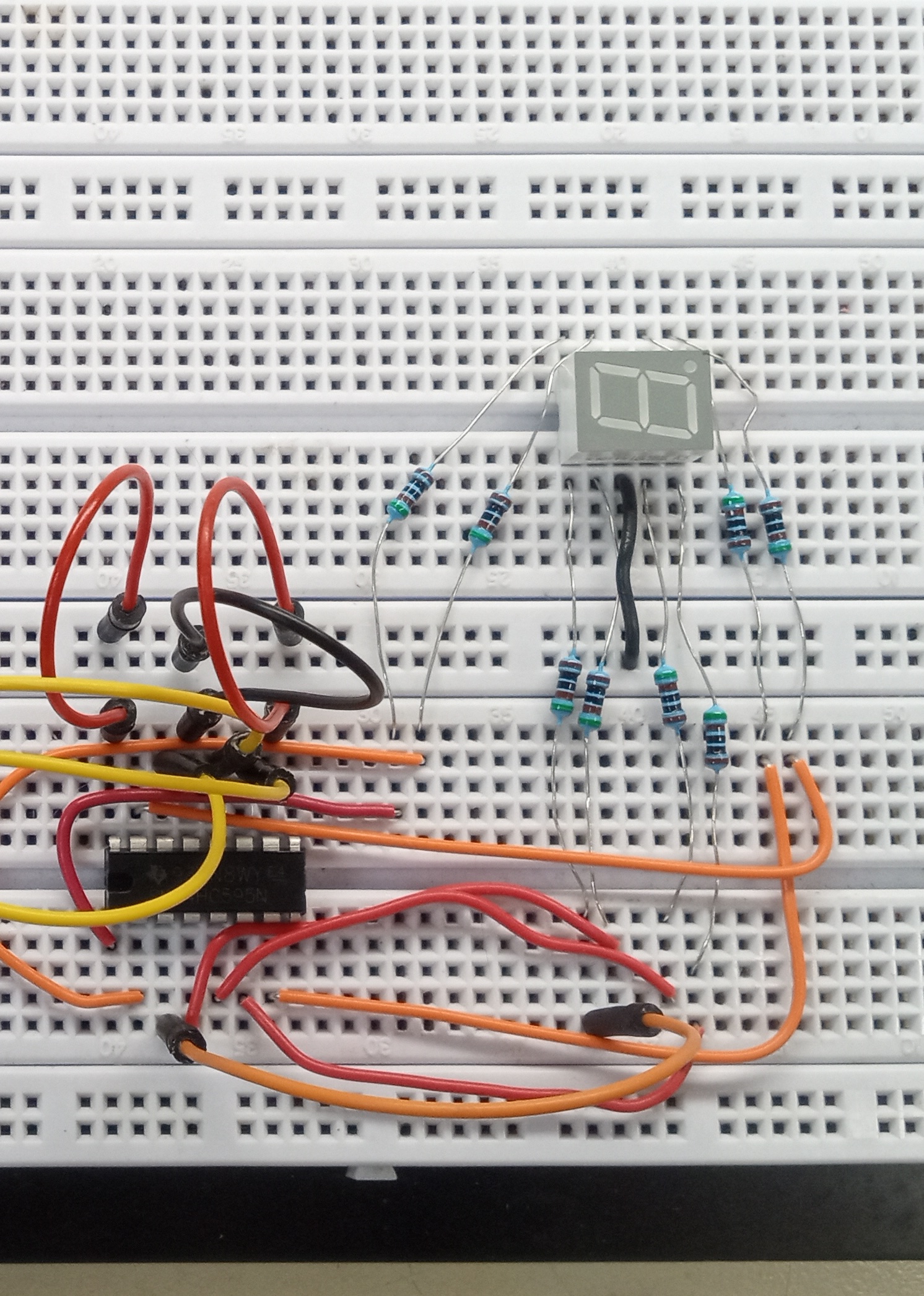 Seven-segment display wired on a breadboard.