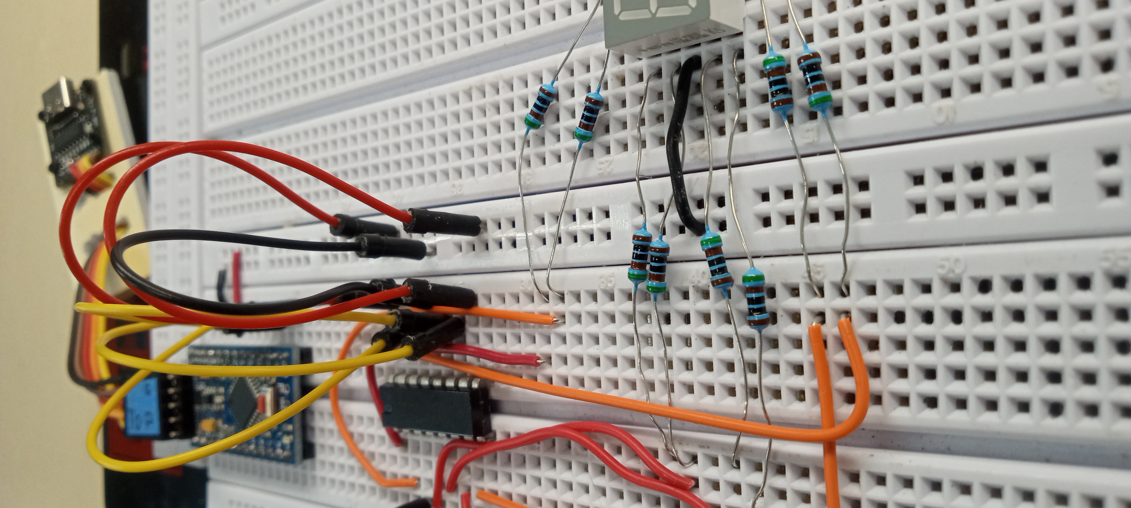Seven-segment display wired to the microcontroller and shift register