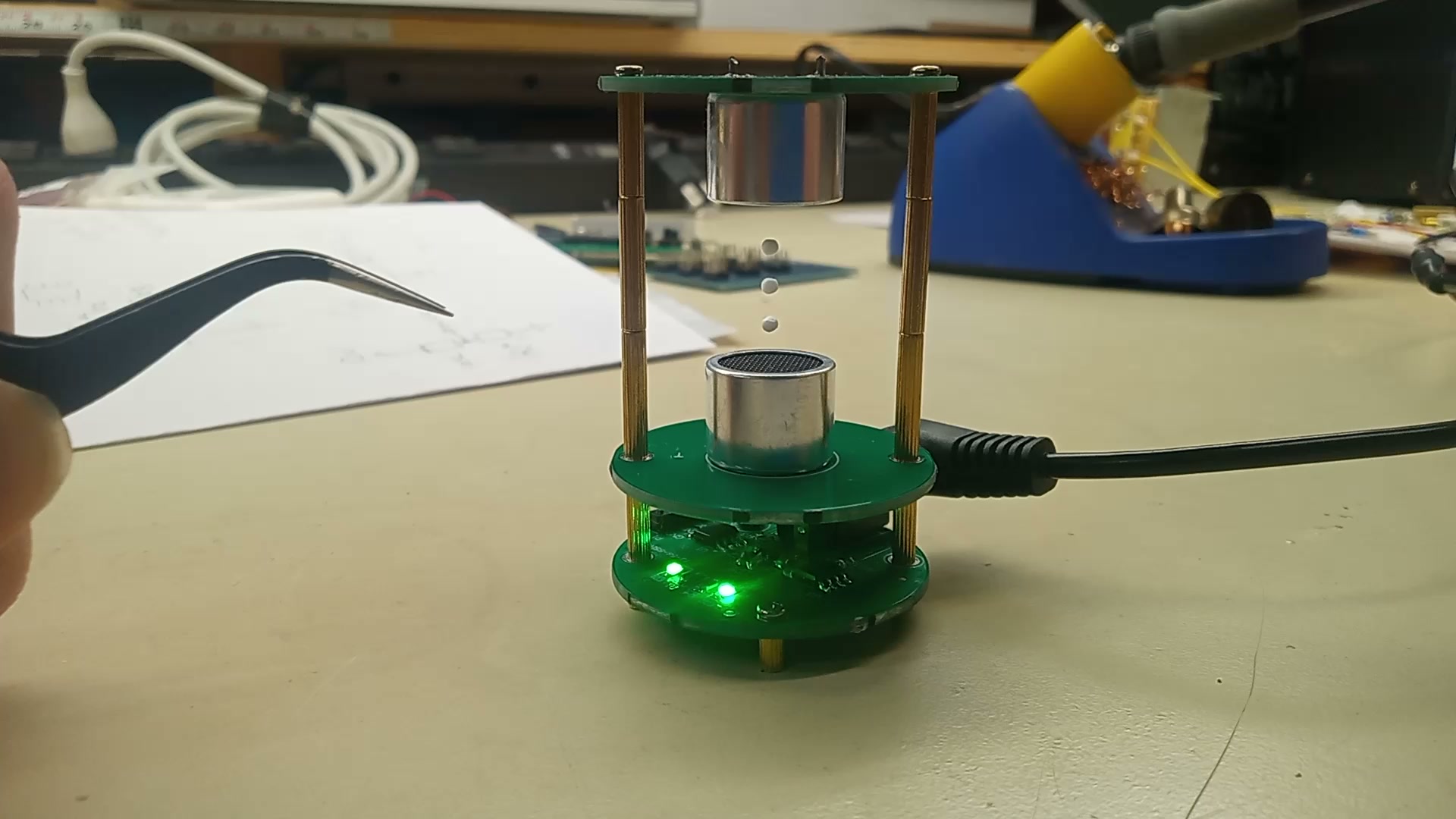 Ultrasonic levitator holding foam balls between two transducers.